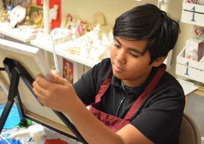 Boy enjoy painting at birthday party