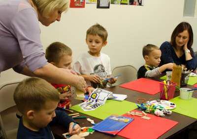 Parent helping child at birthday party