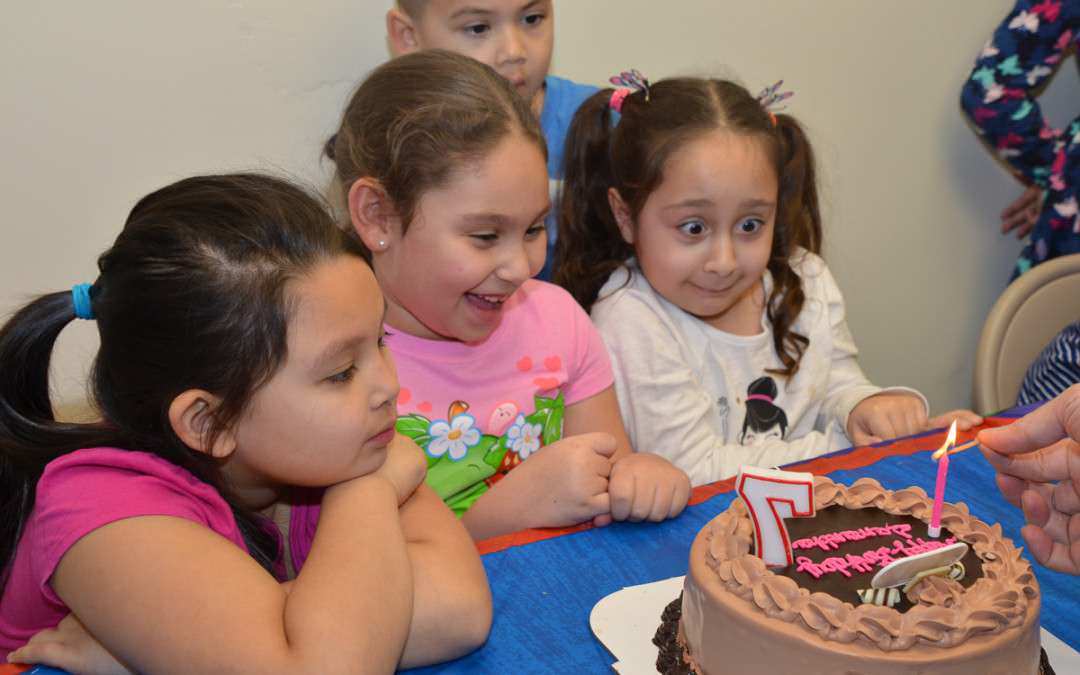 children look at birthday cake