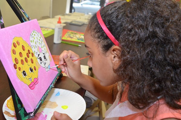 Girl painting on canvas at Art Fun Studio