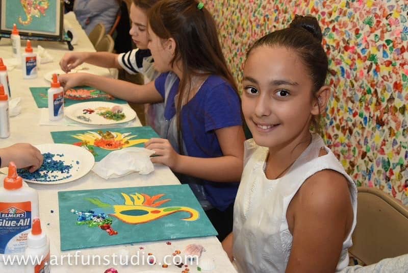 A girl is making mosaic during her birthday party