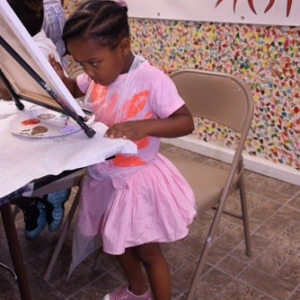 Birthday girl painting during her birthday party