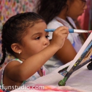 Girl painting during a birthday party