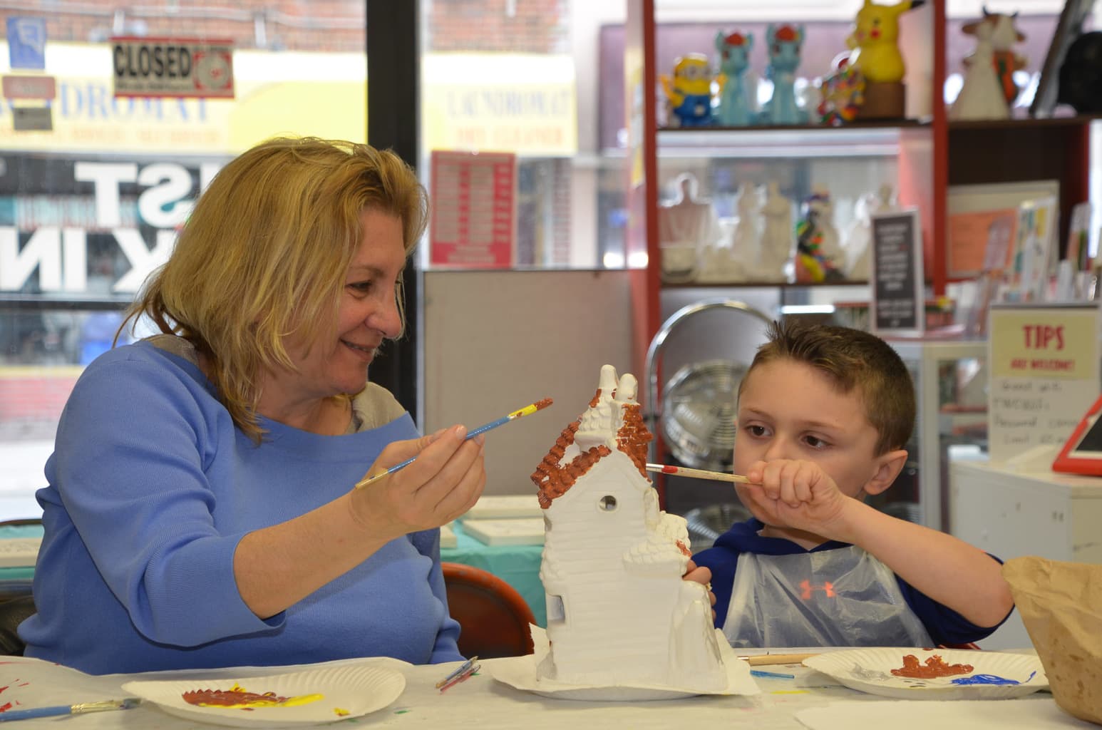 Young boy with Granma painting Halloween House