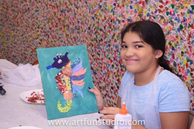 Beautiful girl during a Birthday Party with her own seahorse mosaic