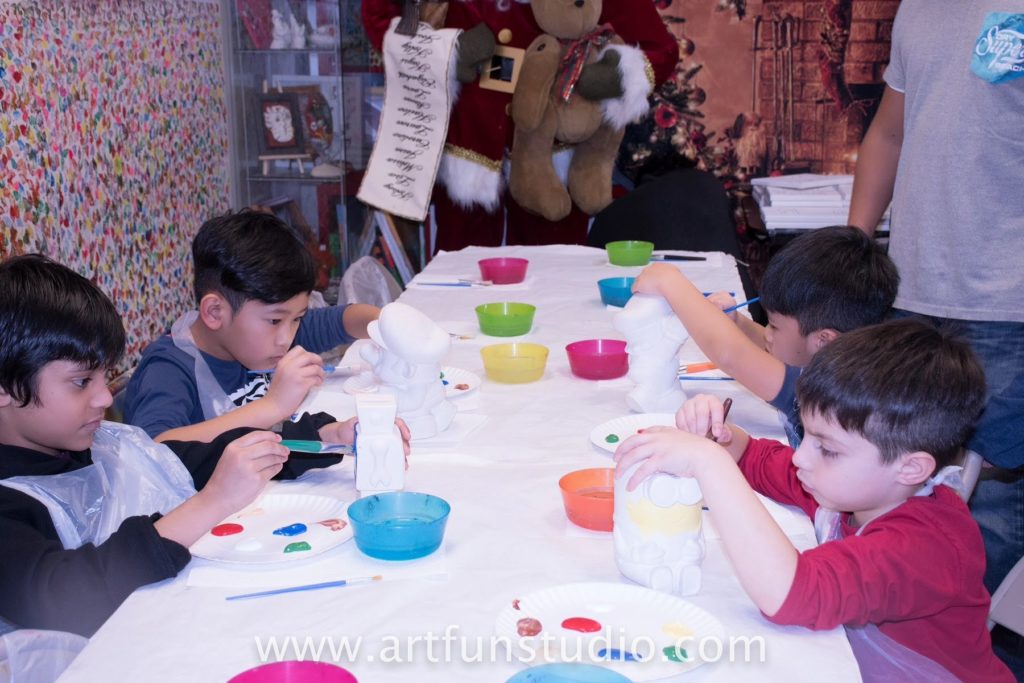 Boys painting plaster figurine during a birthday Party