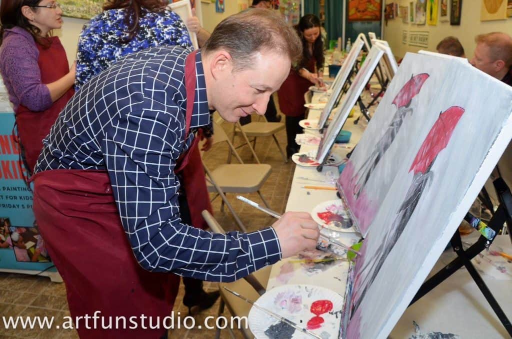 Man paints his art during his own Birthday Party