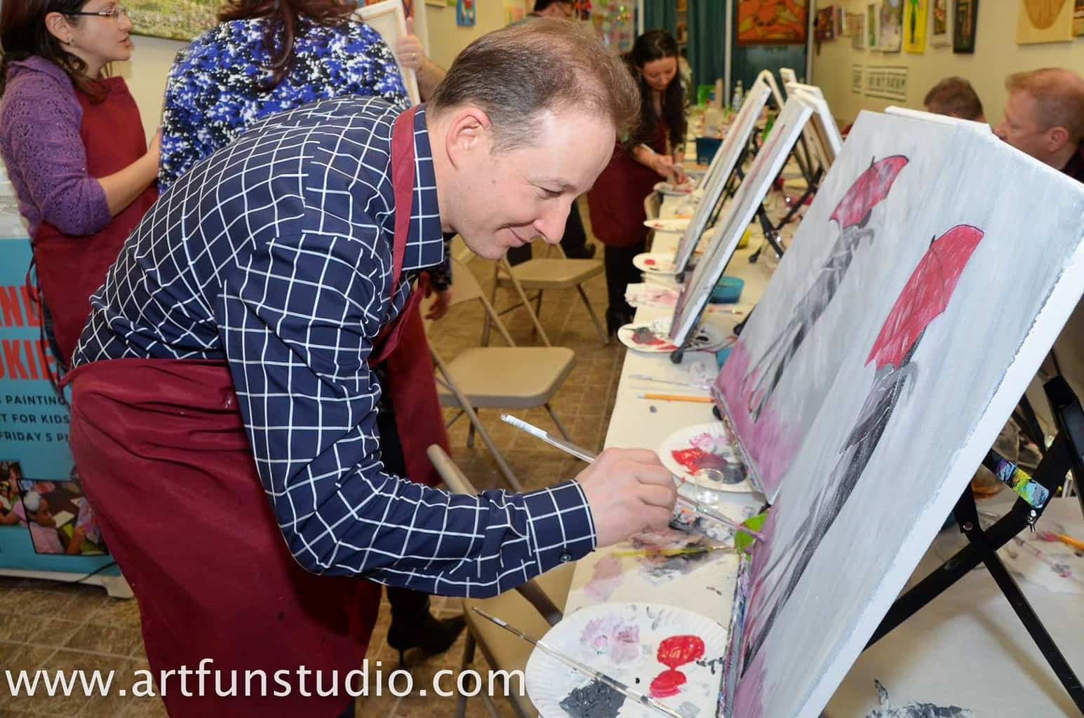 Man paints his art during his own Birthday Party