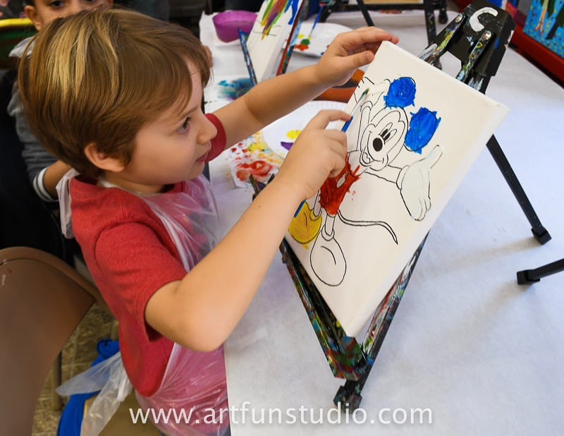 boy painting during a school trip