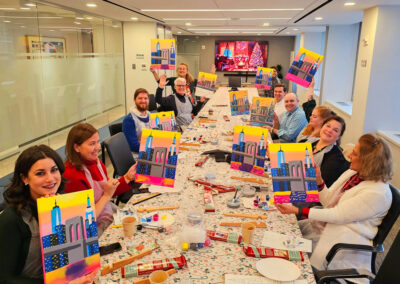 Coworkers during team building paint and sip event in Manhattan office