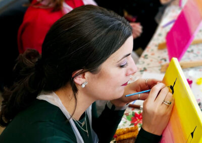 Girl is painting during a corporate sip and paint event in Manhattan.