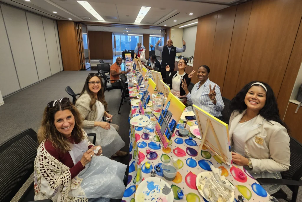People enjoy painting event at law firm in Manhattan