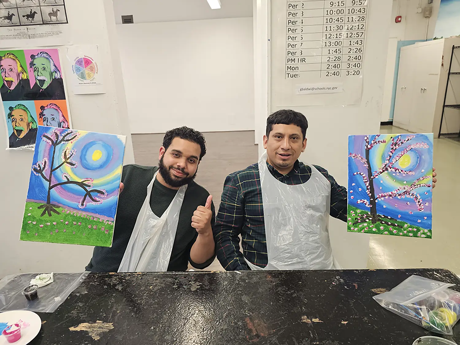 two teachers enjoy their paintings